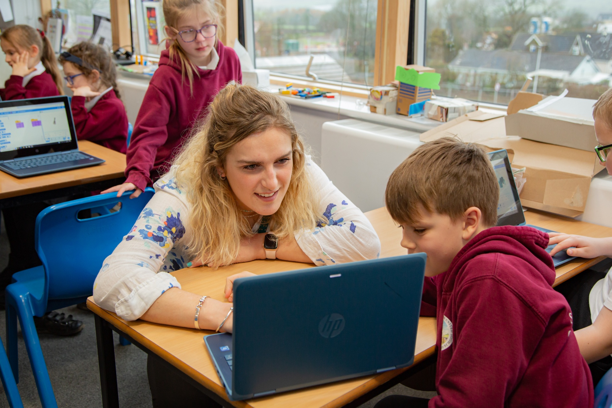 child and teacher with laptop