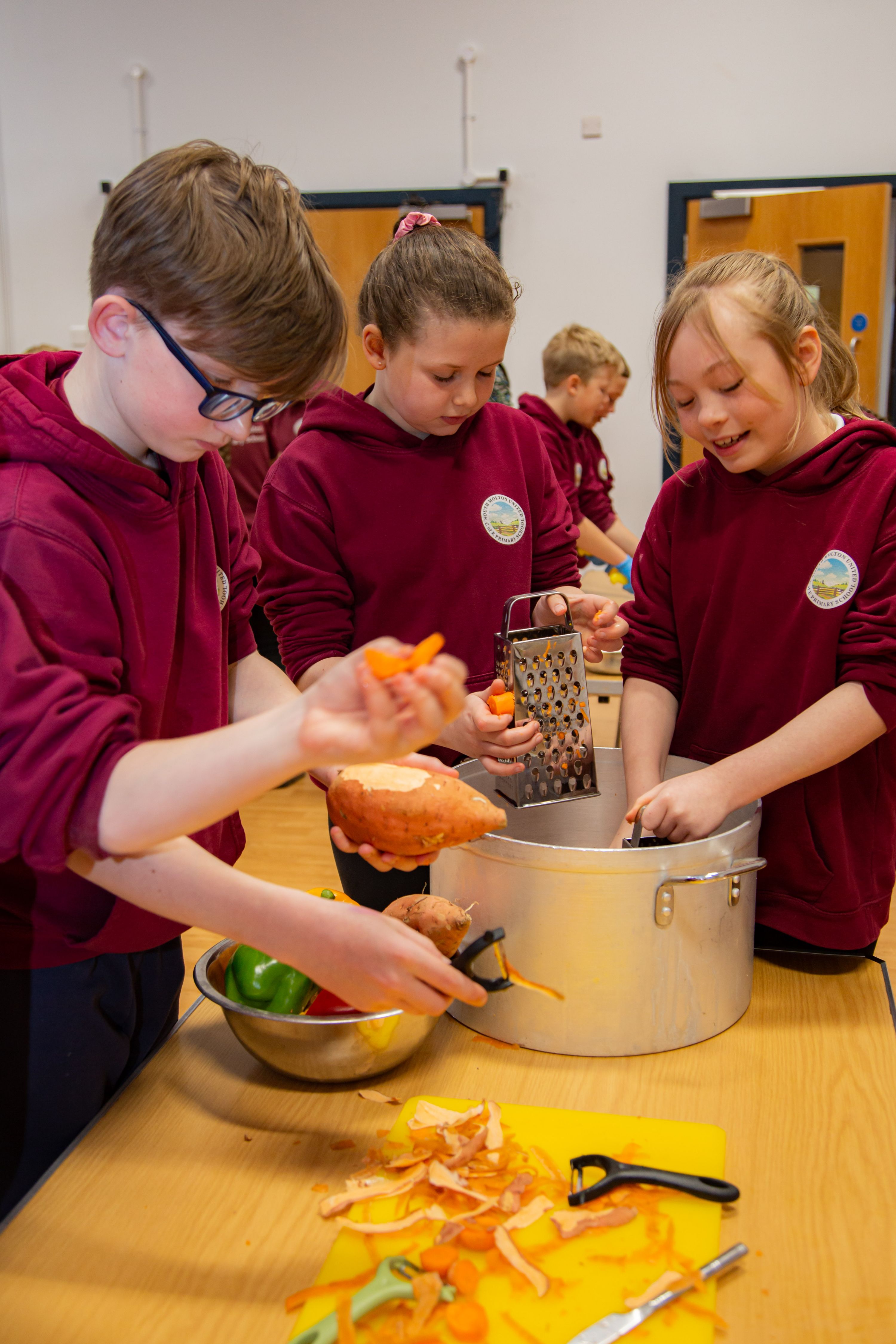 children preparing vegetables to cook